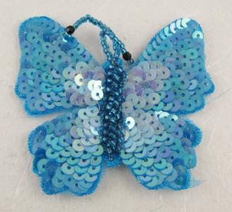 Farfalla con paillettes e perline azzurra